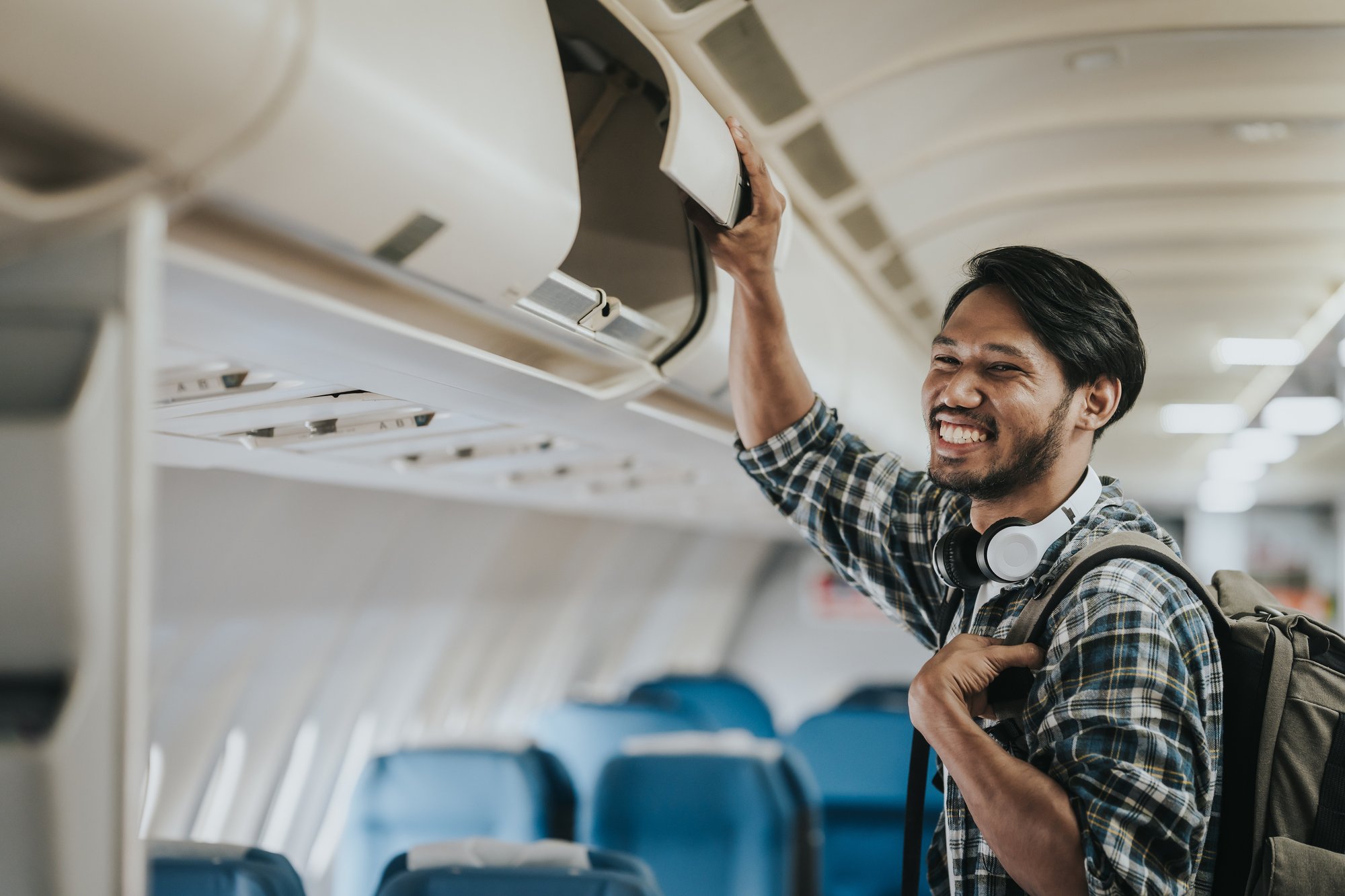 Asian male tourist enjoying airplane travel