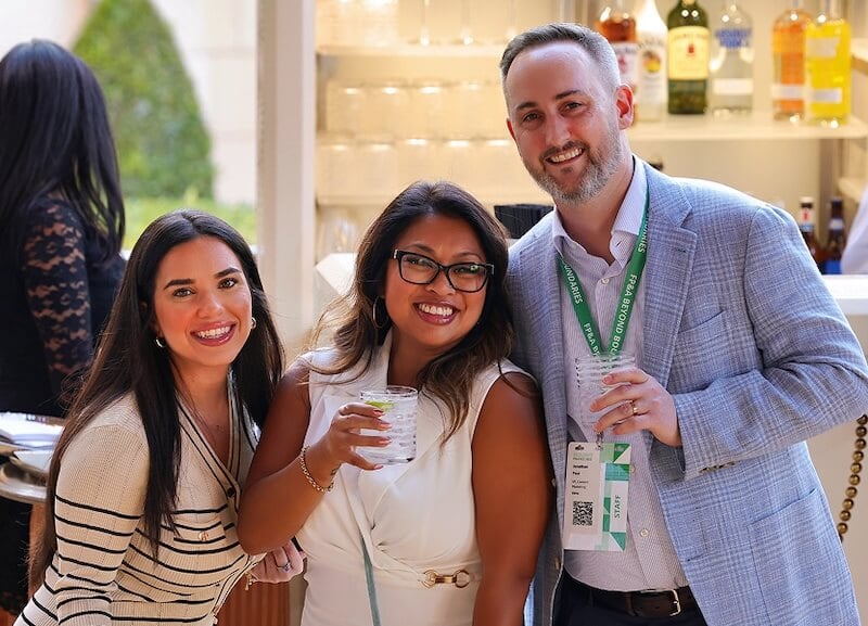 Three adults smiling at camera