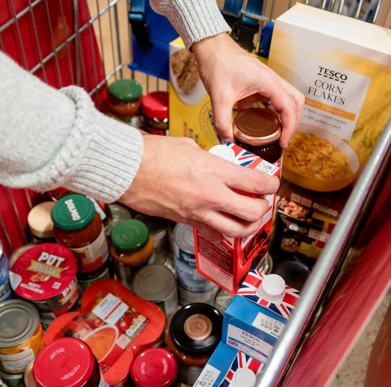 Arms putting items into a shopping cart