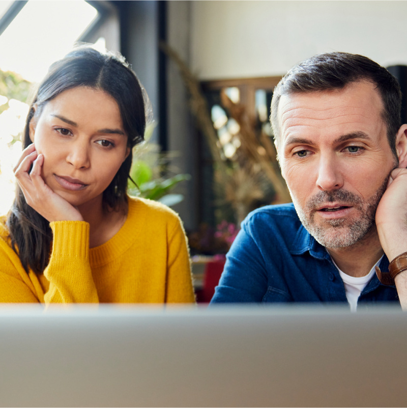 Focused business colleagues watching laptop in bright office