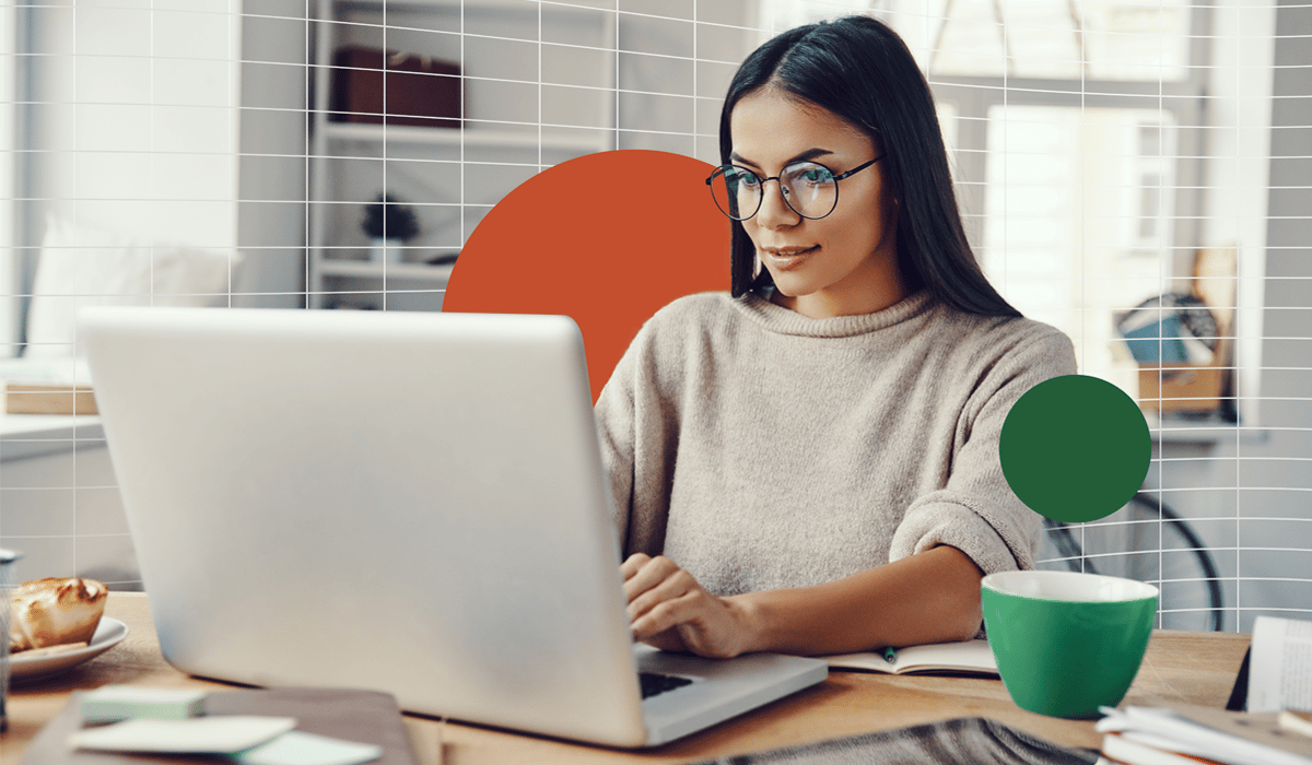 Image of a woman working on her laptop in a home office environment