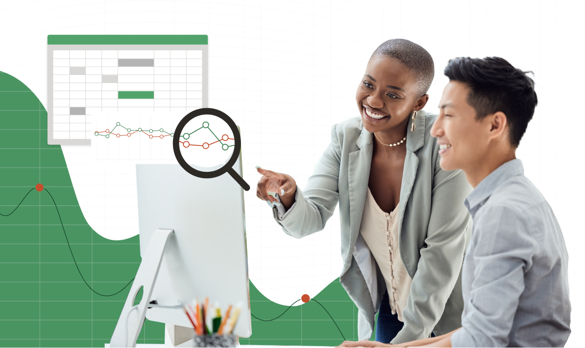 Two finance professionals are looking at a computer screen together.