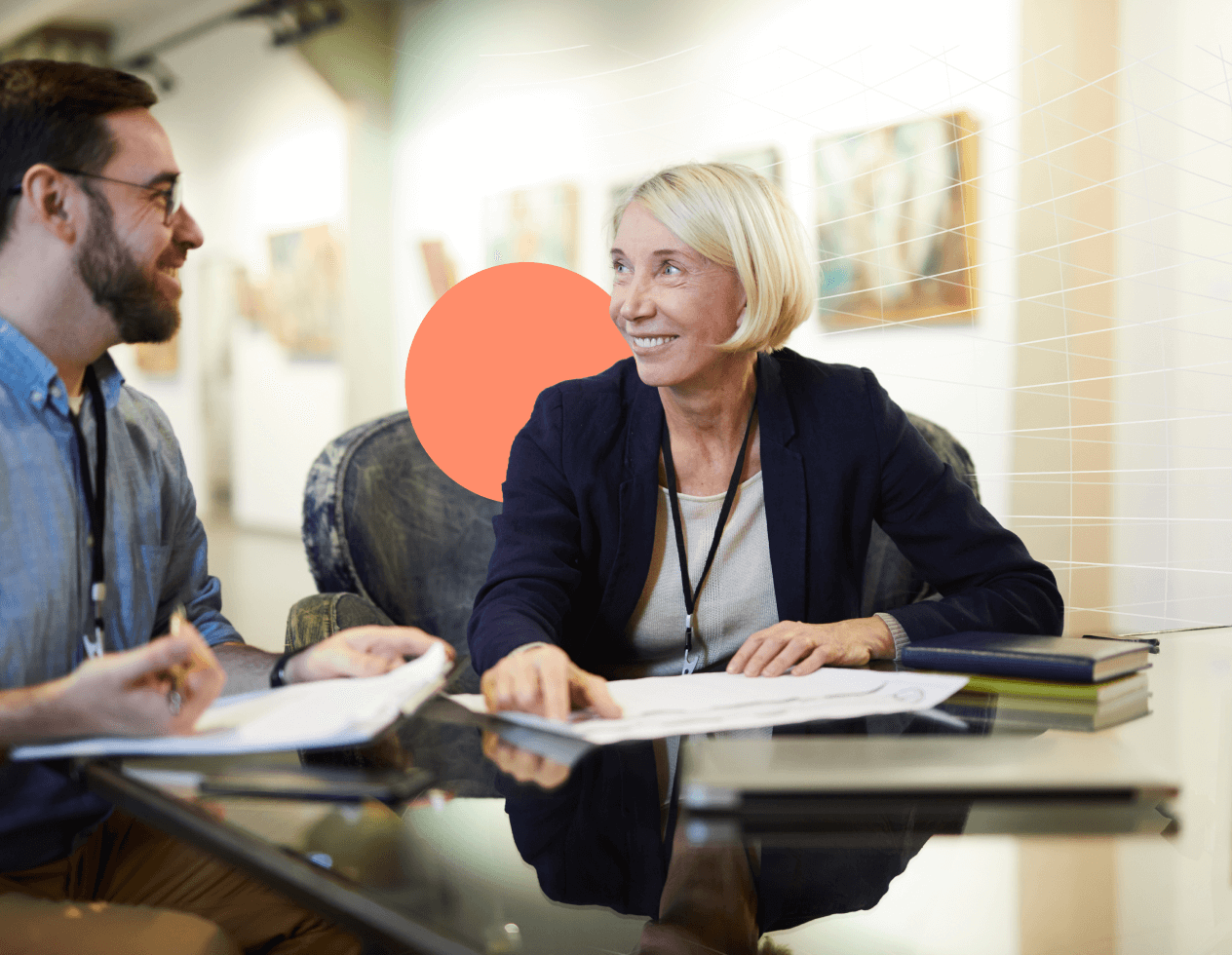 Branded image of two museum curators working together at a desk.