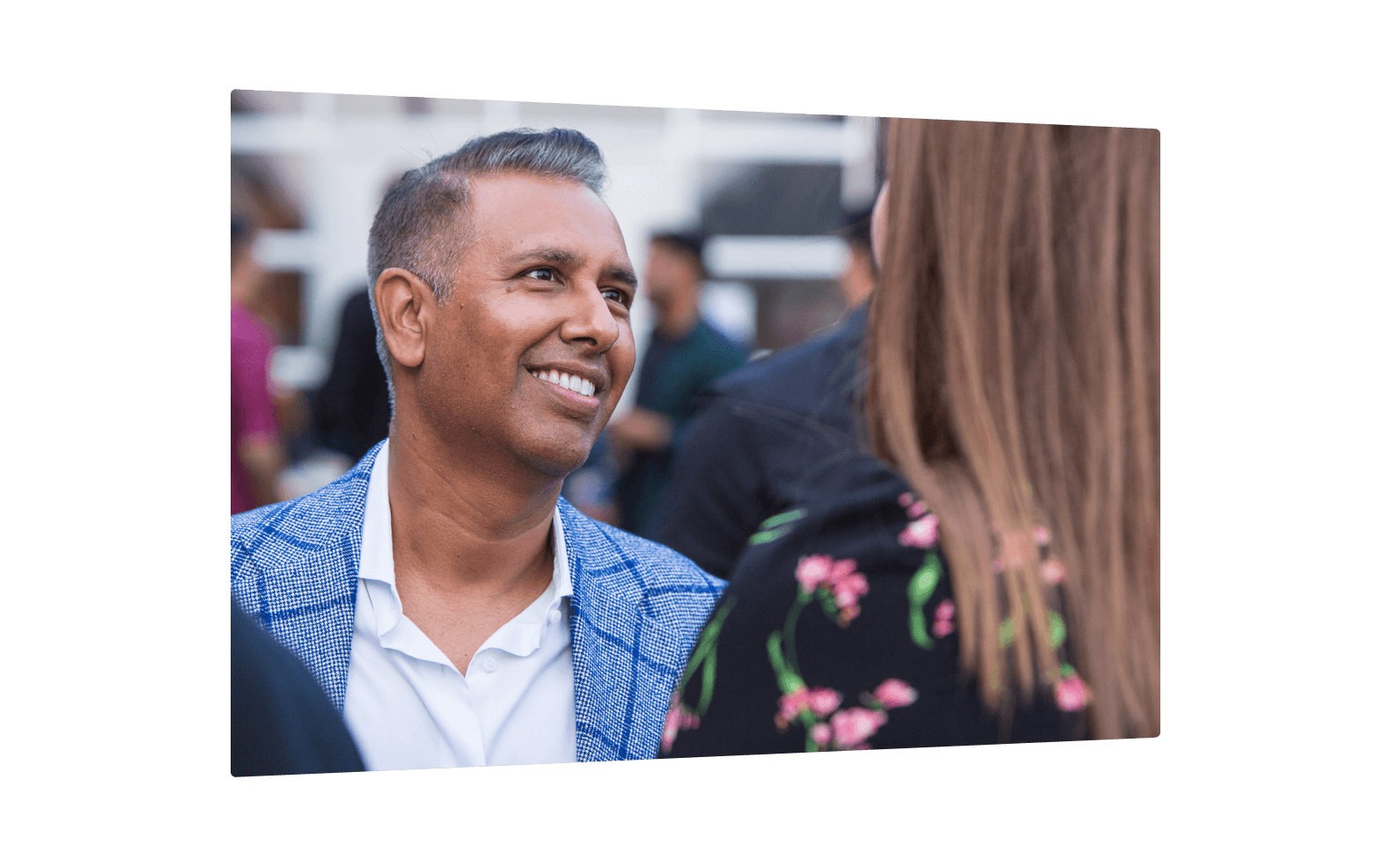 A man and a woman standing in an office, speaking to one another